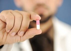 doctor offers capsule to treat lower back pain